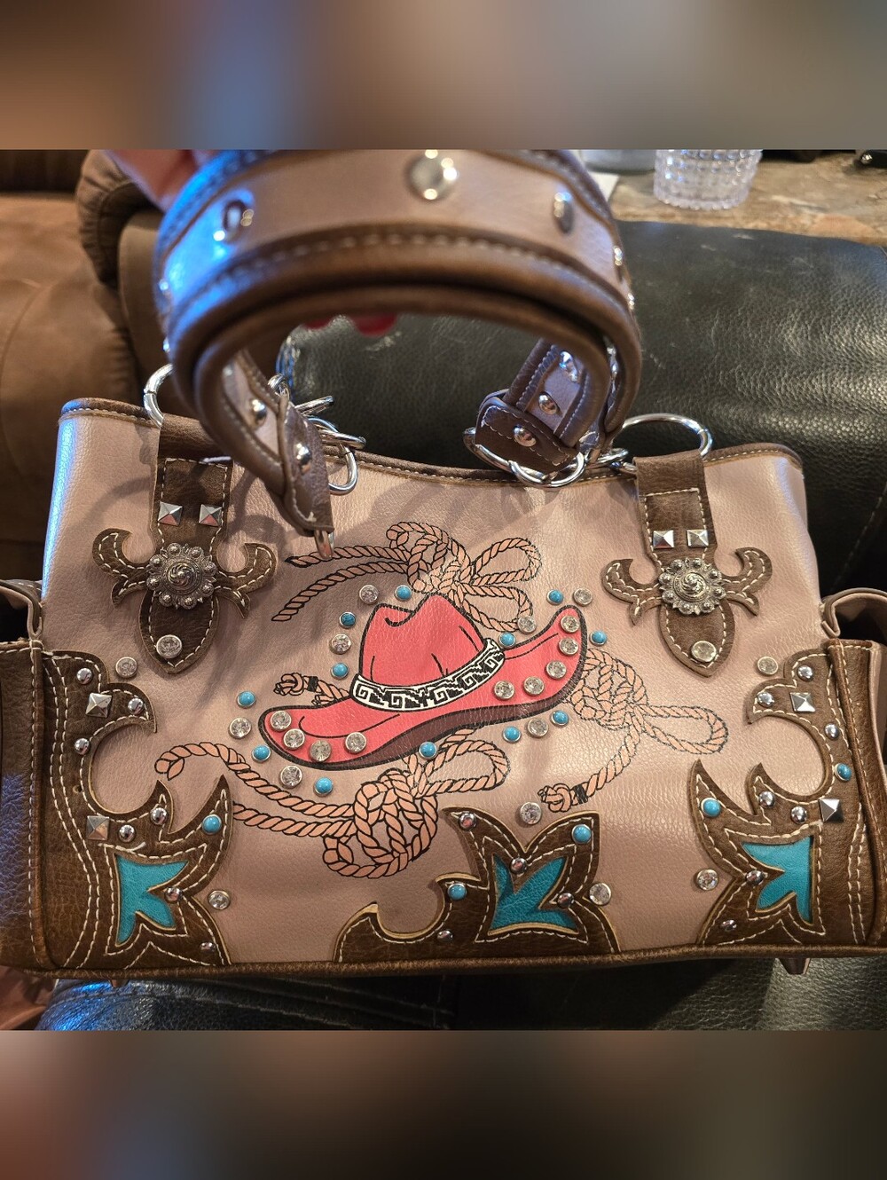 Cowgirl Trendy handbag features a red cowboy hat graphic adorned with rhinestone